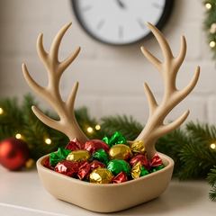 A 3D printed Reindeer Antler Bowl in a natural beige colour, filled with wrapped Christmas candies, sitting on a table with festive greenery. Close-up of the 3D printed texture on a unique antler-shaped snack bowl. The Reindeer Antler Bowl (Large size) used as a centrepiece on a Christmas dining table.