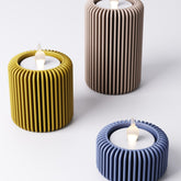Fin tealight holder, ribbed fluted design, shown in a neutral colour with an LED tealight