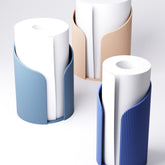 Ridged paper towel holder on a kitchen counter with a roll of towel loaded