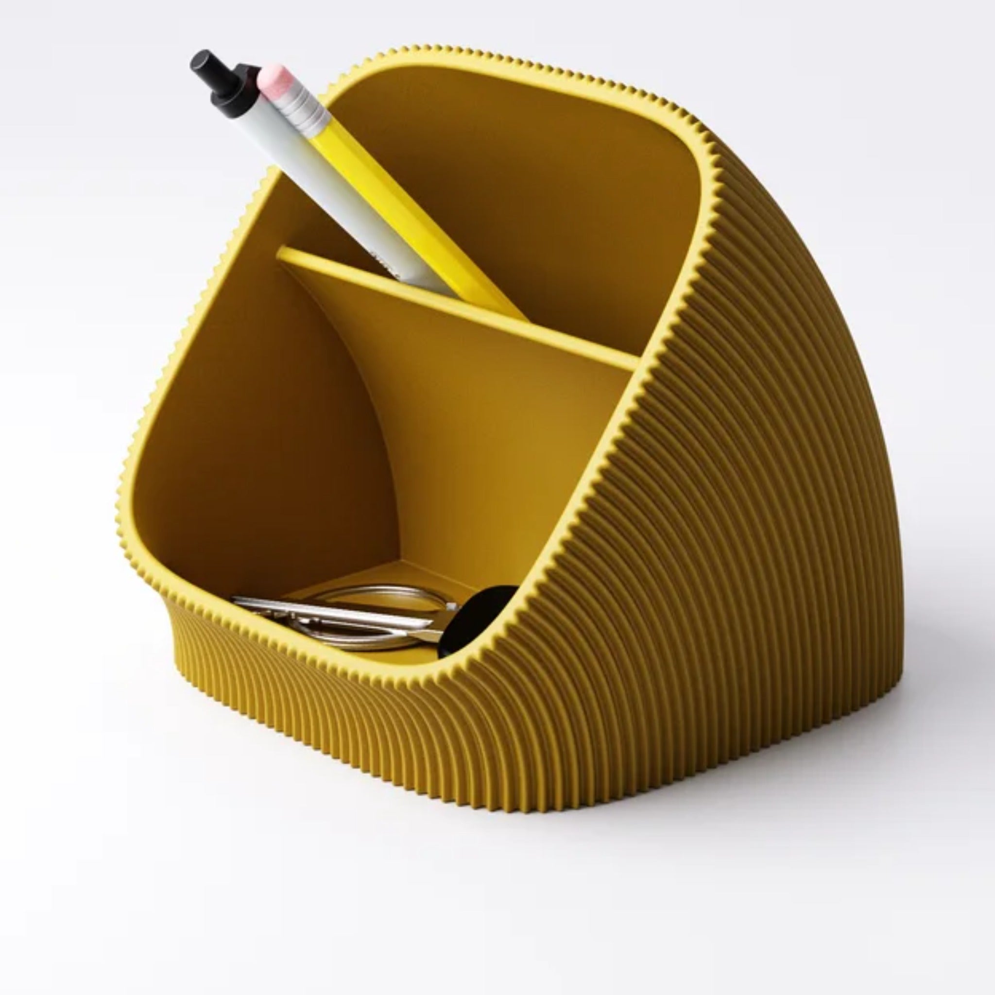 Pleated desk organiser shown on a desk beside everyday stationery for scale
