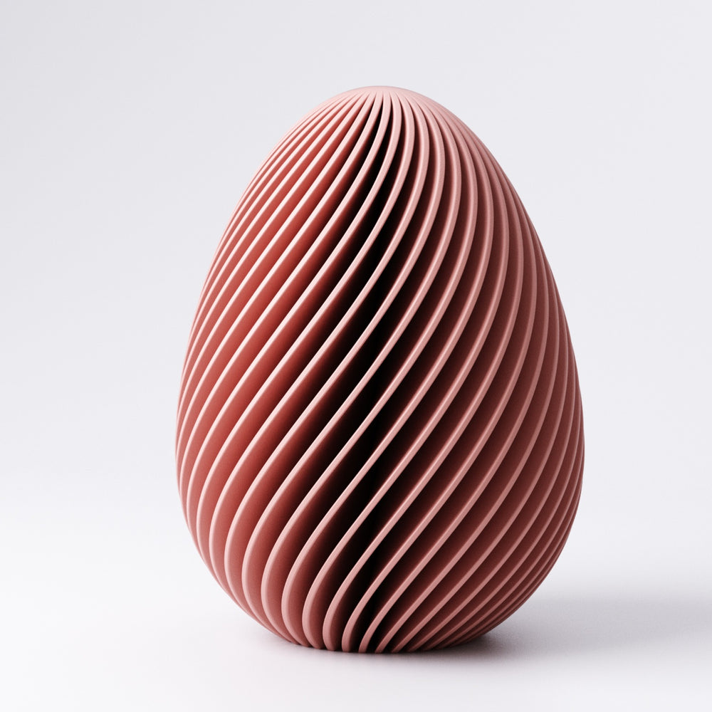 Easter egg decoration with twisted fin texture in Mandarin Orange on a windowsill