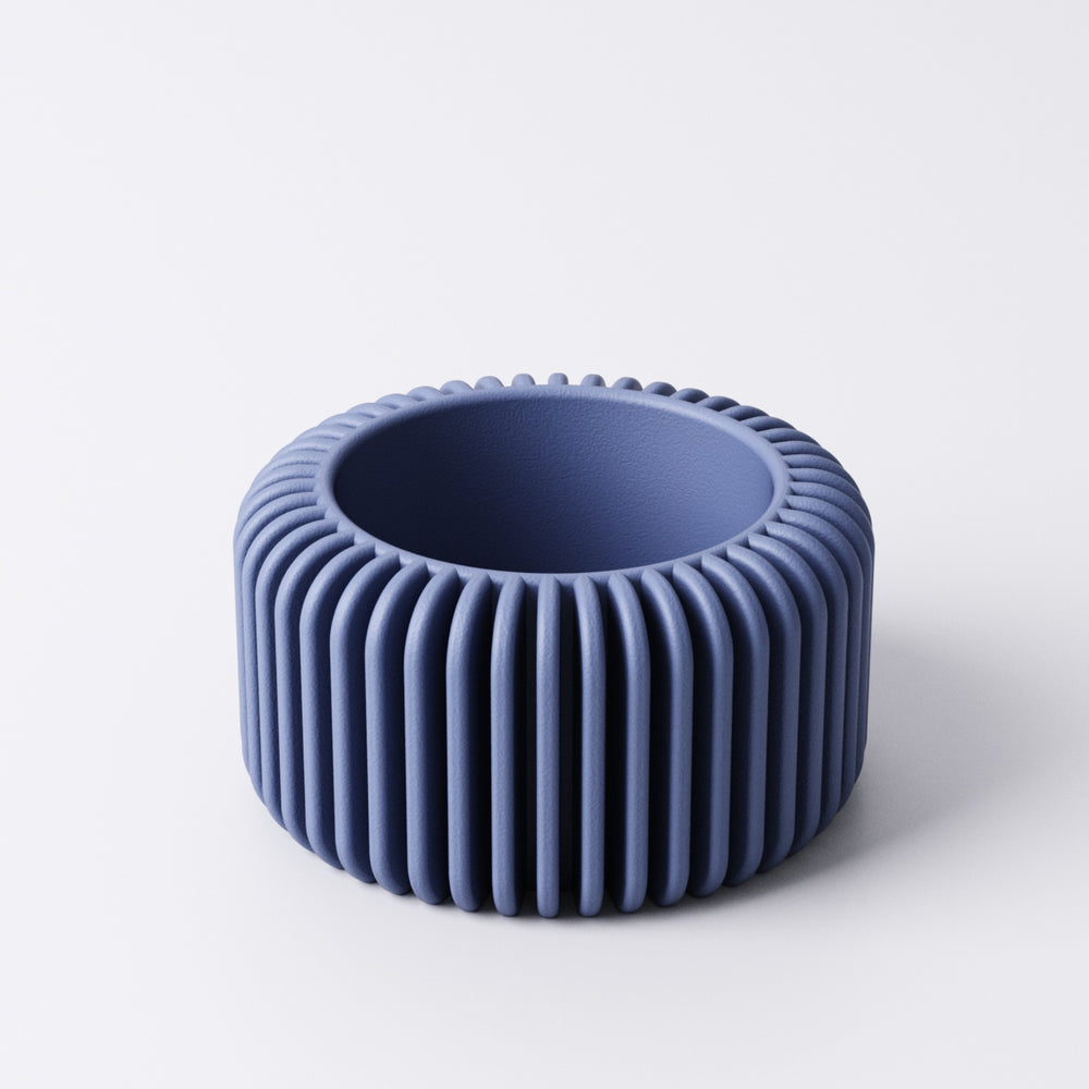 Fin tealight holder, angled view showing the ribbed texture and open top