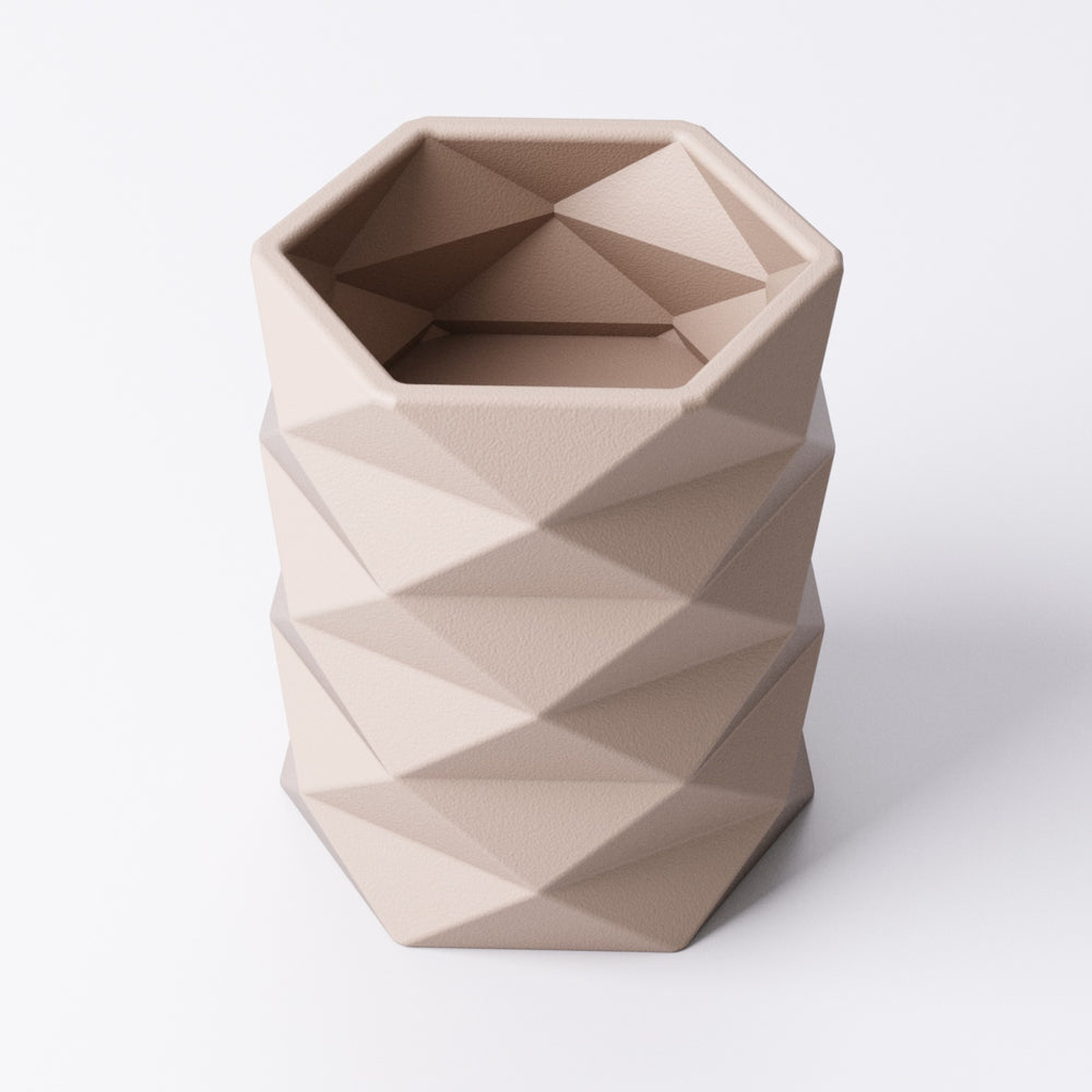 Geometric tealight holder, front view showing the faceted texture