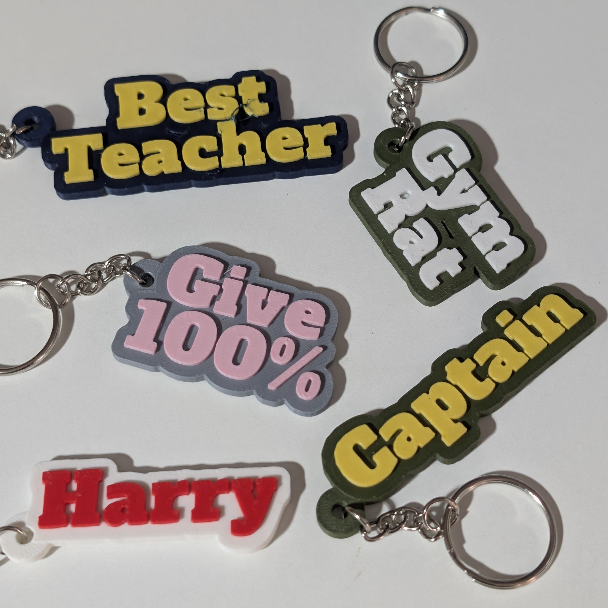 Personalised name keyring designs with raised text in a variety of colours