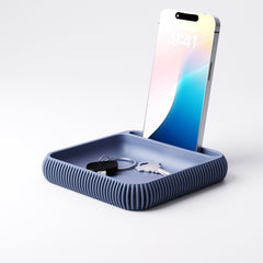 Phone holder and tray styled on a student desk beside books and stationery