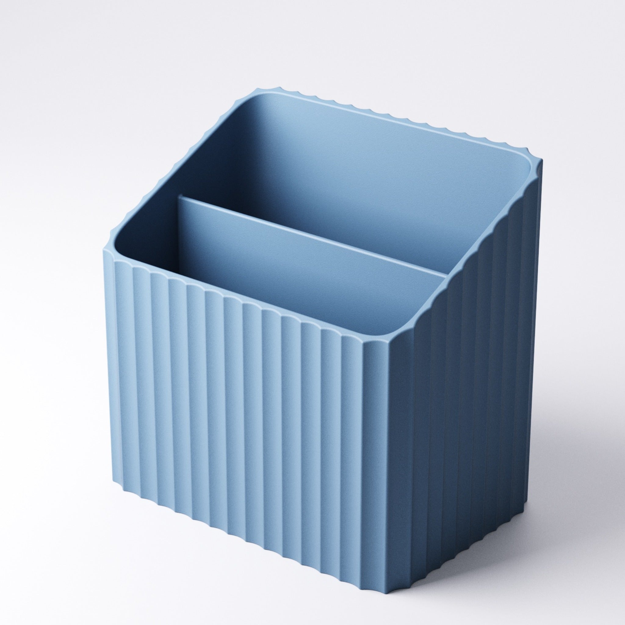 Ribbed remote holder with wide and narrow sections styled on a shelf