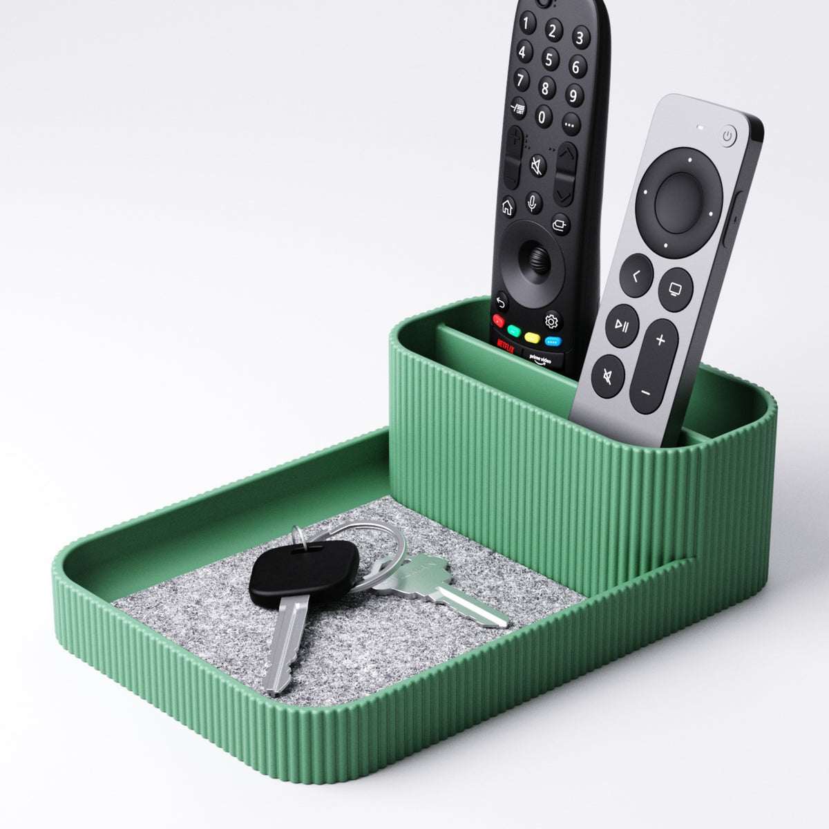 Remote control holder with tray in green, holding three remotes upright