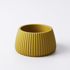 Mustard yellow ridged tealight holder, Small size, angled view showing the fin-textured ridges and open top