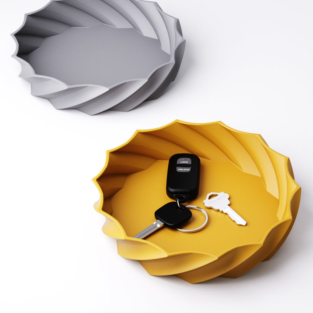 Spiral catchall bowl in Mandarin Orange holding keys and coins