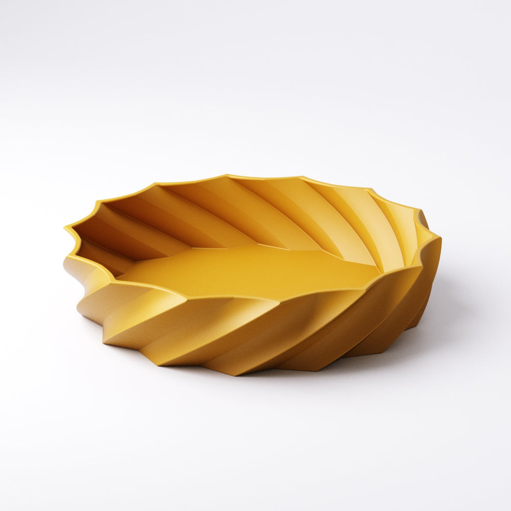 Spiral catchall bowl styled on a desk holding everyday clutter