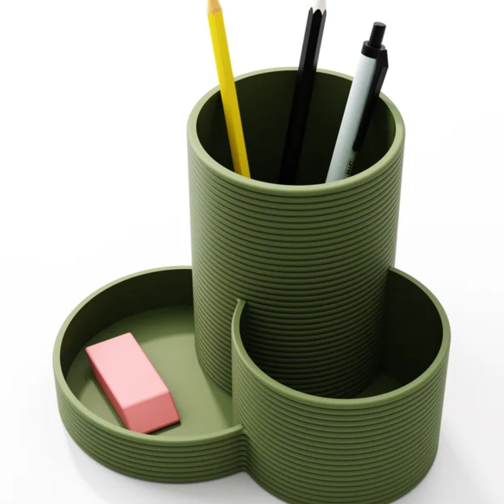 Round pen and stationery organiser shown with pens and an eraser