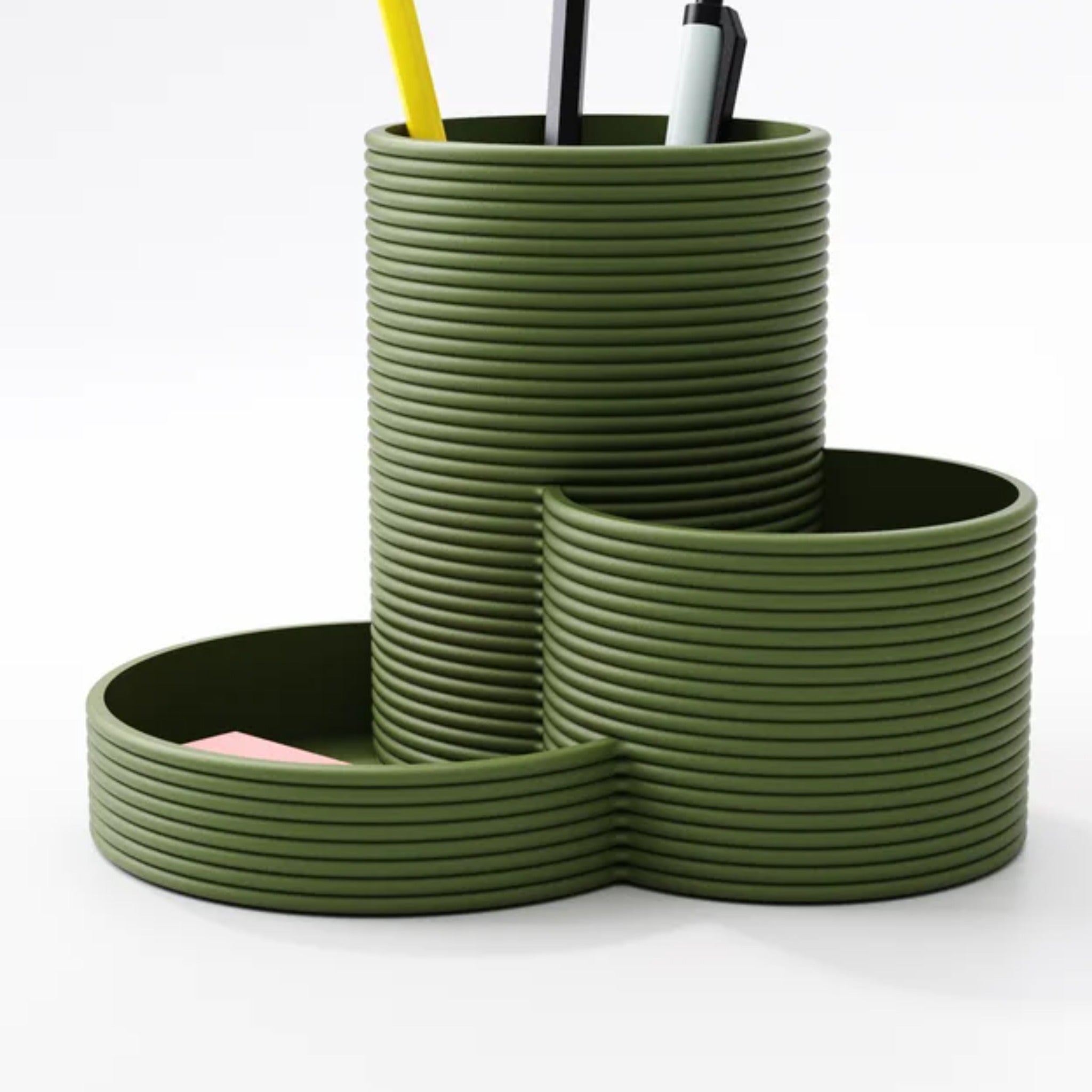Close-up of the tiered pen pots and small clip tray on a home office desk
